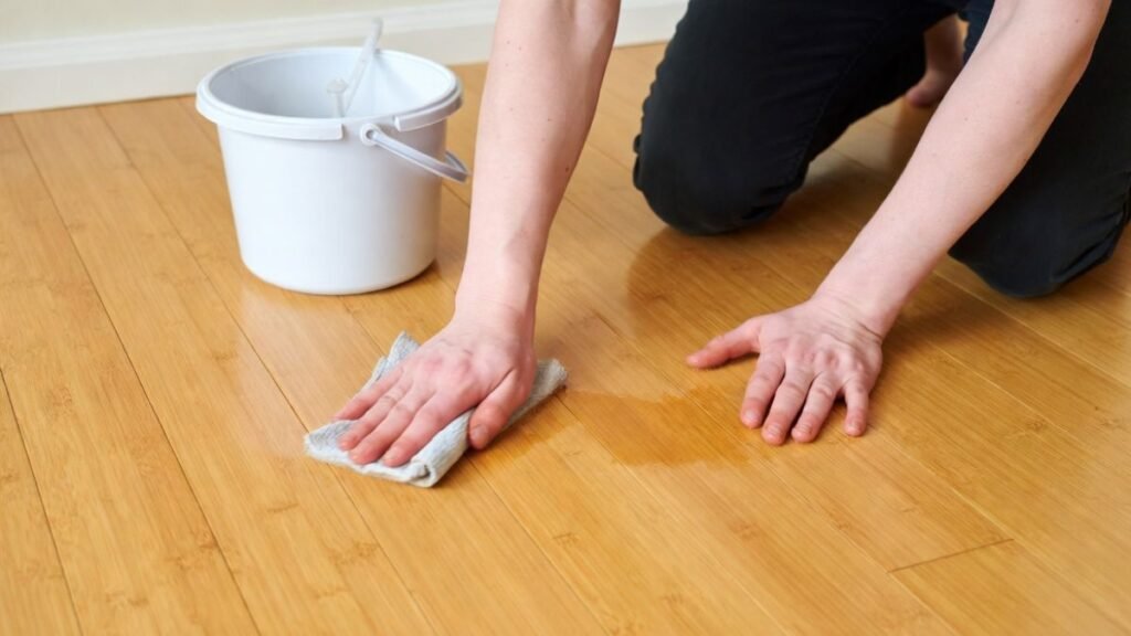 A person Removing Scuff Marks from a bamboo wooden floor with a cloth